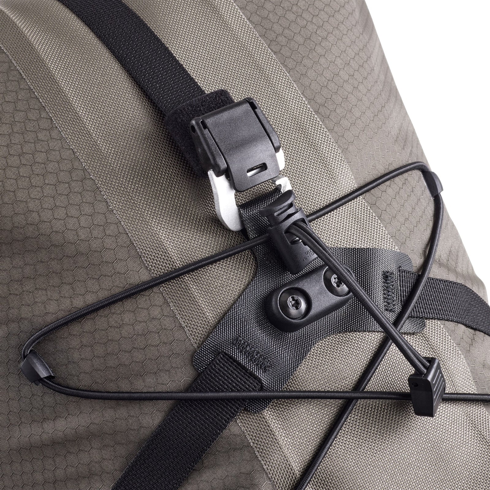 Close-up of an ortlieb bicycle backpack with a strap and buckle detail on a gray background