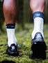 compressport pro racing trail socks, quarter length compression trail running sock, light turquoise with dark turquoise band and purple detail, model wearing sock close up of back of sock