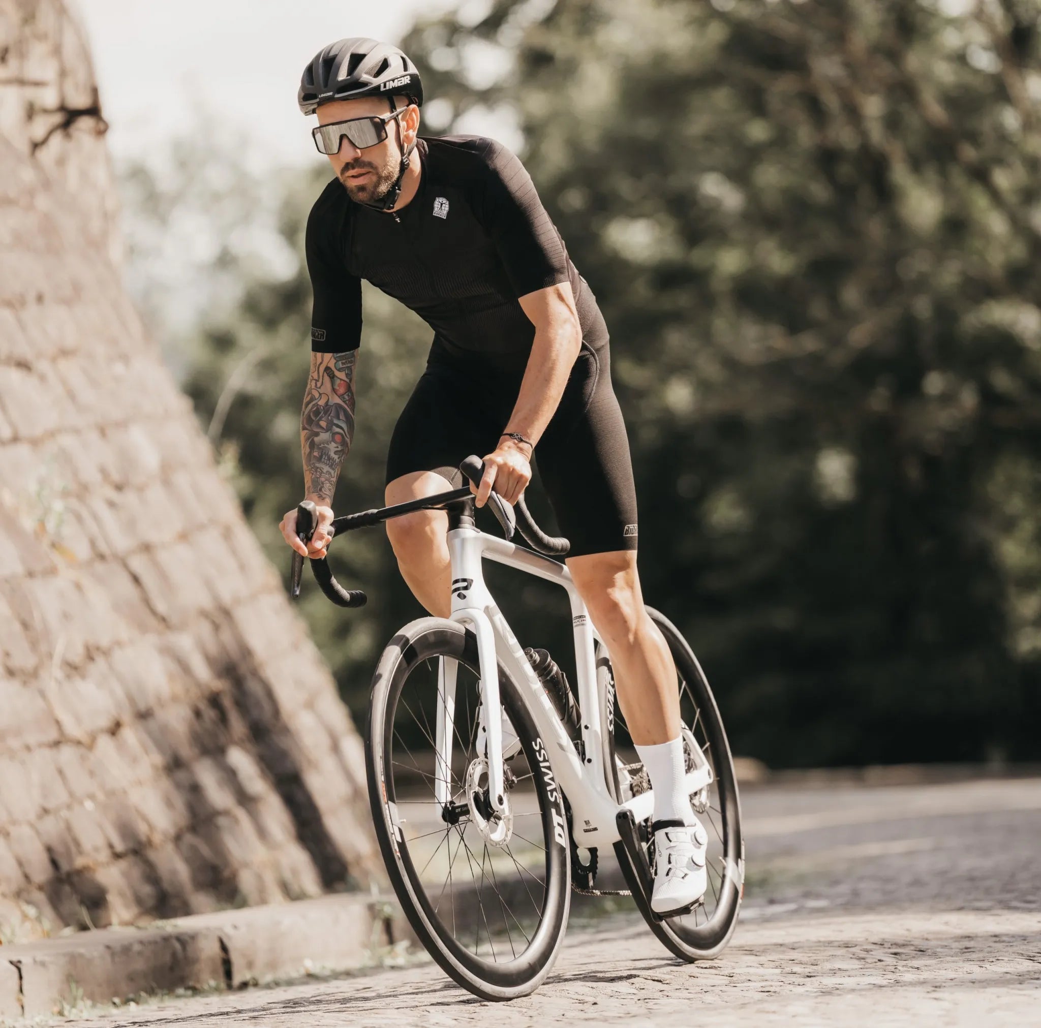 man riding a ridley falcn bike in white