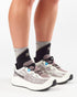 woman wearing salomon aero glide grvl 4 running shoes for women in vanilla ice colour