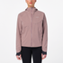 Woman wearing the salomon bonatti waterproof jacket, in antler colour, showing taped zip on front and salomon logo