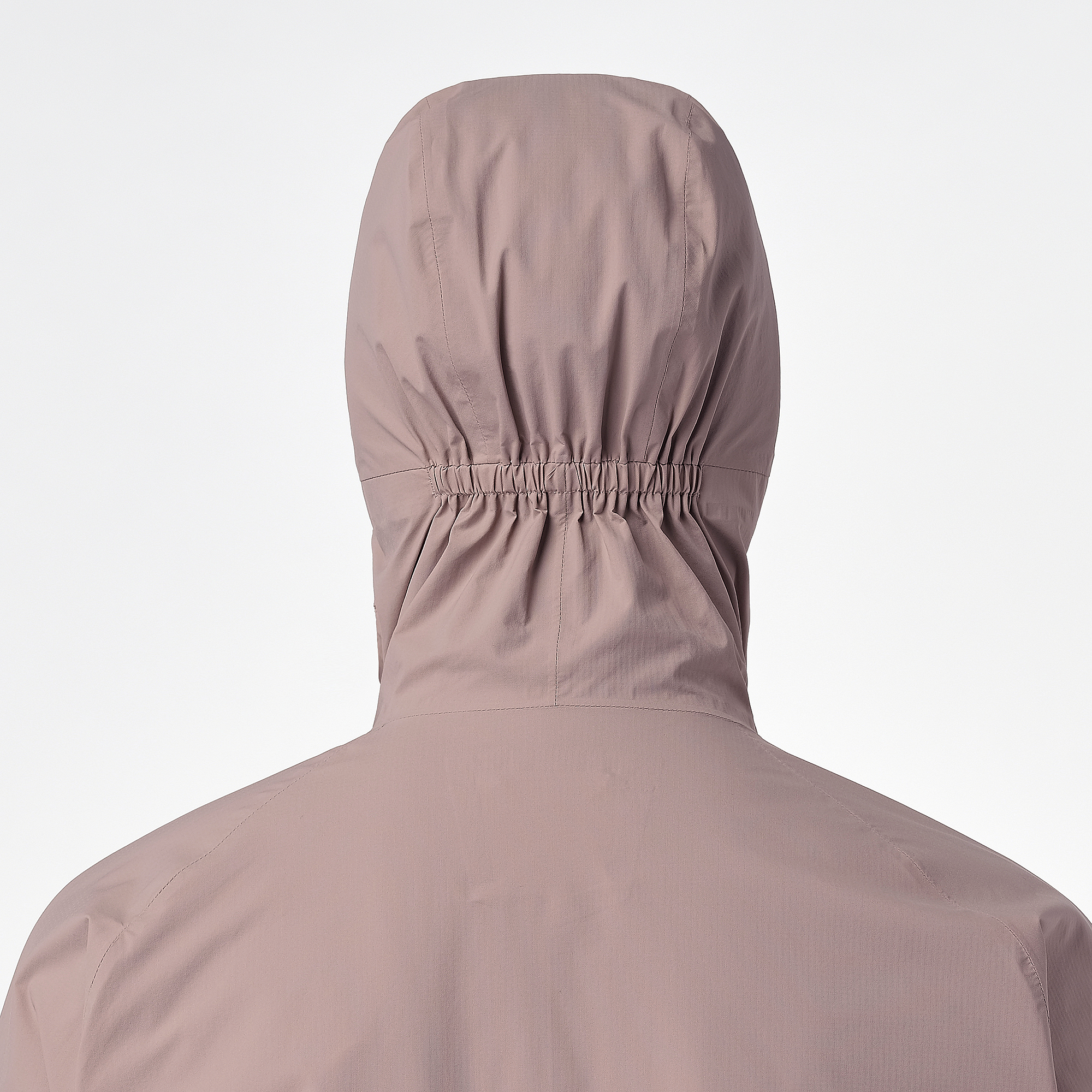 Close up of the hood on salomon bonatti waterproof jacket, in antler colour, showing elasticated feature to prevent hood blowing down in wind