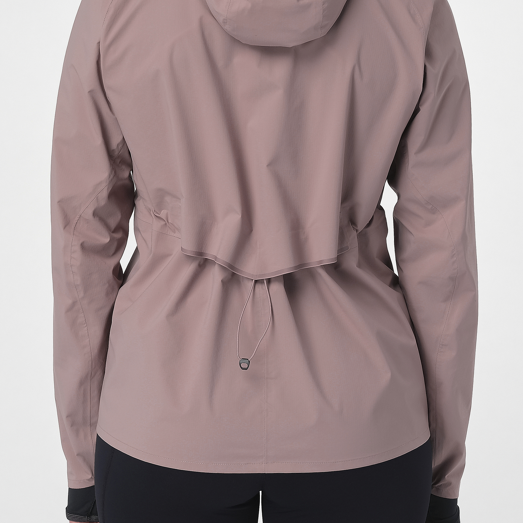 Close up of the salomon bonatti waterproof jacket, in antler colour, showing the drawstring pulled in at the waist
