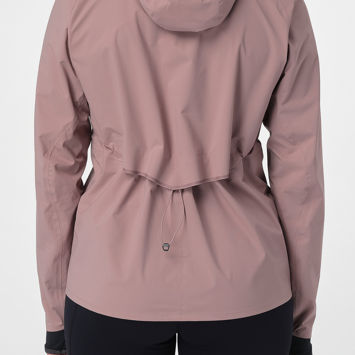 Close up of the salomon bonatti waterproof jacket, in antler colour, showing the drawstring pulled in at the waist