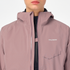 Woman wearing the salomon bonatti waterproof jacket, in antler colour, close up of button feature on chest to prevent jacket opening in the wind