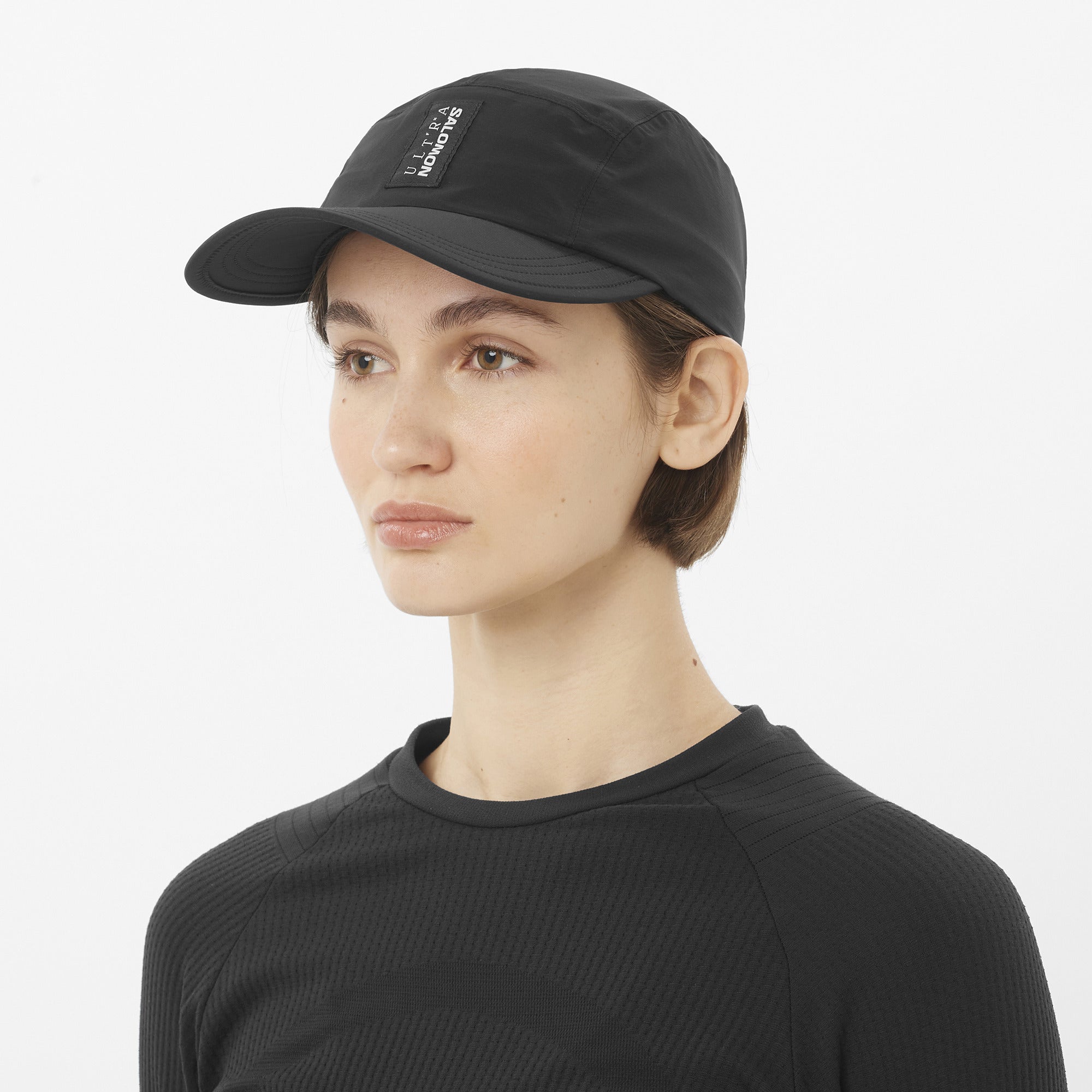 salomon s lab ultra cap, waterproof adjustable hat, black colour, woman wearing salomon hat front view