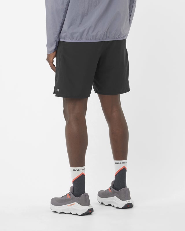 man wearing Salomon Shakeout Core 2in1 7" run short showing back with Salomon S logo