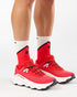 mens salomon ultra glide 4, mens trail shoe in the fiery red, vanilla ice, black colourway. picture of the shoes being worn by a model with a white background