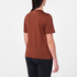 salomon shakeout core short sleeve running t-shirt for women, light and breathable run tee, dark burgundy colour with white salomon logo, back view of model wearing salomon tee on white background with black leggings 