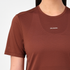 salomon shakeout core short sleeve running t-shirt for women, light and breathable run tee, dark burgundy colour with white salomon logo, close up of model wearing salomon tee on white background 