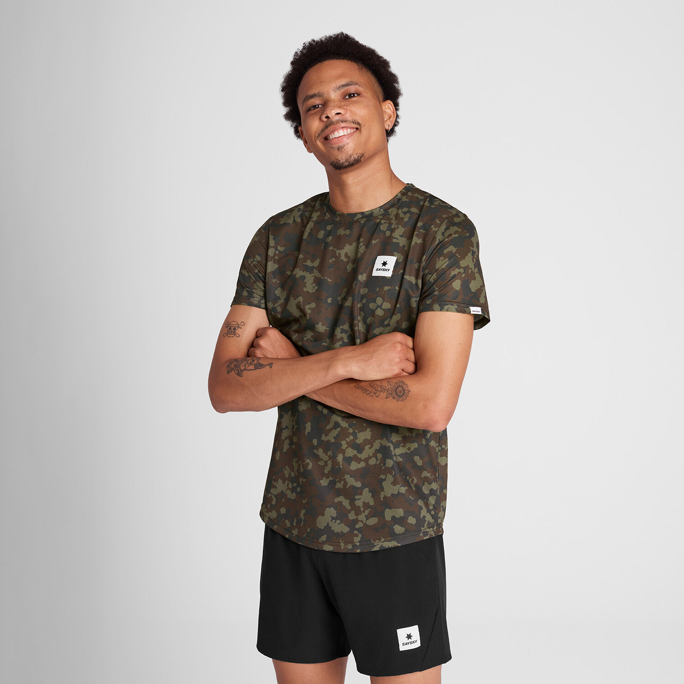 man wearing saysky camo running tee with logo on front