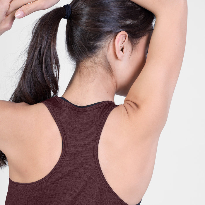 saysky clean combat pro singlet for women, lightweight tank for running or the gym, burgundy colour, close up view of the racerback detail, model wearing singlet on a white background