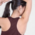 saysky clean combat pro singlet for women, lightweight tank for running or the gym, burgundy colour, close up view of the racerback detail, model wearing singlet on a white background