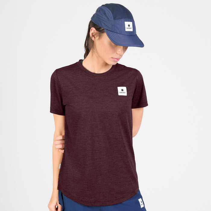 saysky clean combat pro t-shirt, lightweight running top for women, burgundy colour, view of model wearing t-shirt with a navy hat and shorts on a white background