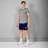 saysky short sleeve running t-shirt for men in grey, stretchy and quick-drying running tee, full body profile of man wearing saysky t-shirt and navy shorts