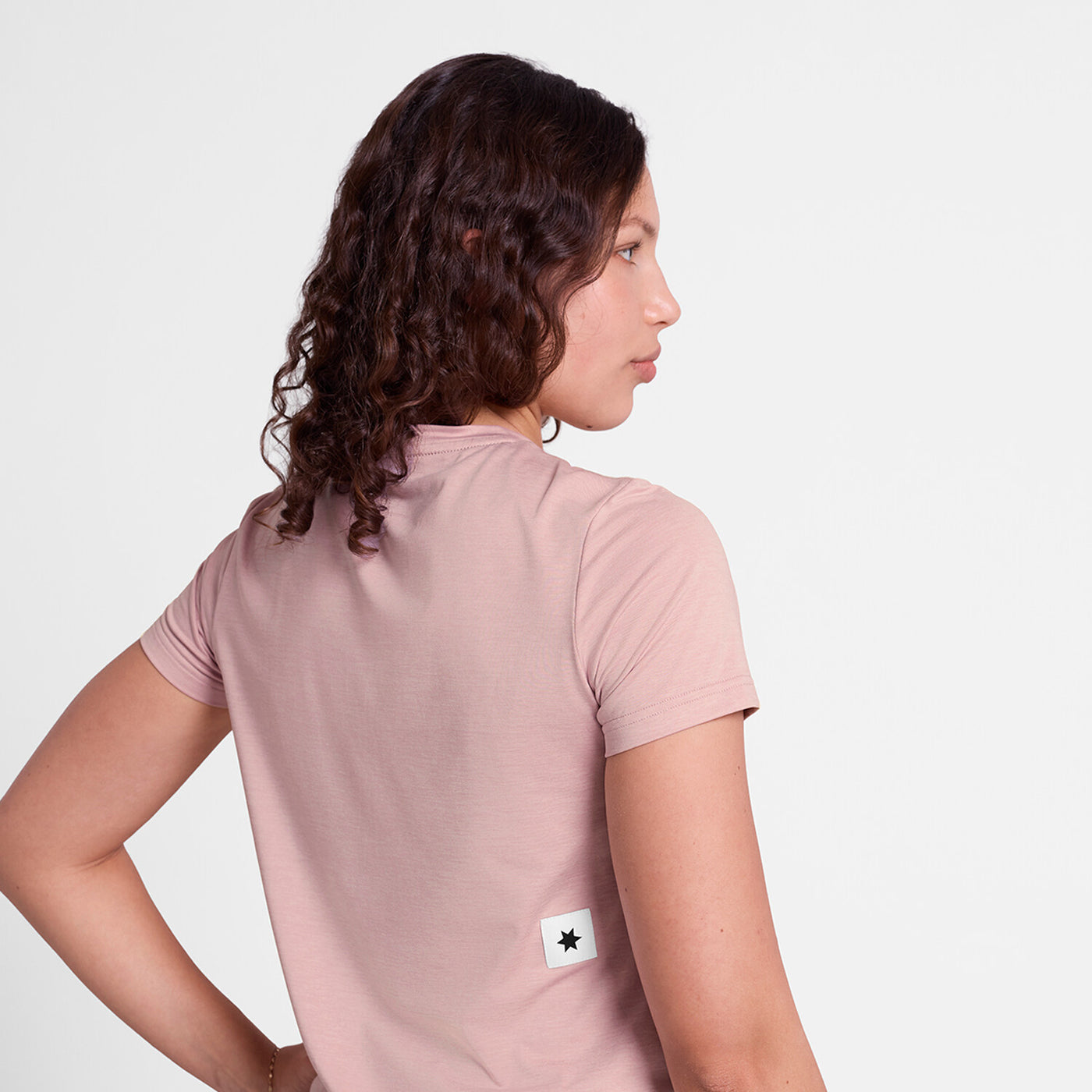 saysky clean pace tshirt for women, quick dry soft running tshirt, light pink colour, women facing backwards wearing pink saysky running top