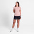 Women's light pink short-sleeved running t-shirt by SAYSKY, full-body shot of a woman wearing pink t-shirt and black shorts