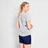 woman wearing saysky run tshirt with flower pattern and logo at back