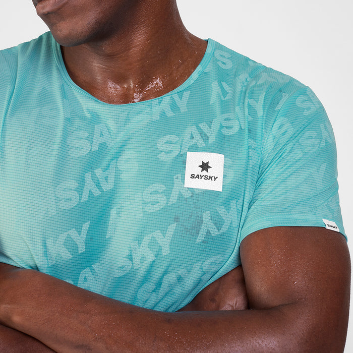 Close up of green SAYSKY Reactive run tee shirt, that displays the saysky pattern when wet