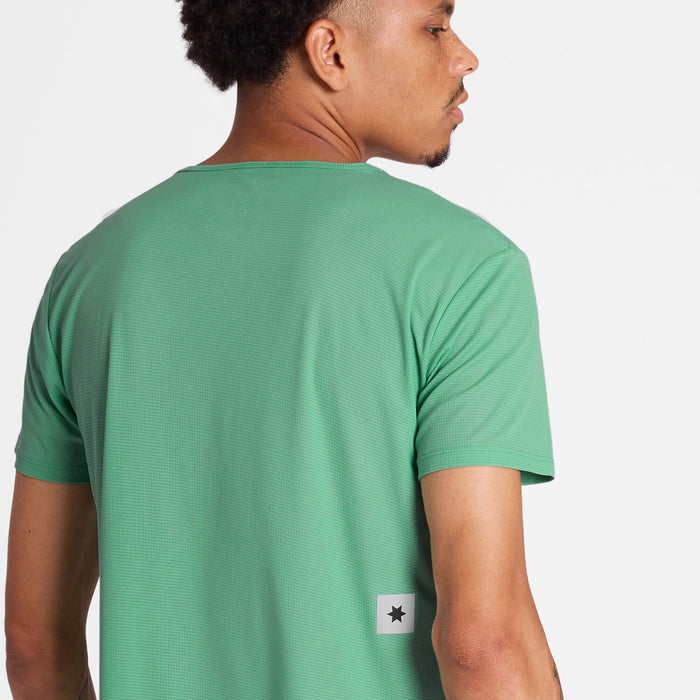 Man showing the back of a green SAYSKY run tee shirt with reflective logo mid back