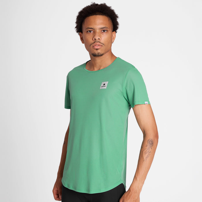 Man wearing a green SAYSKY running t-shirt with a small white logo on front chest