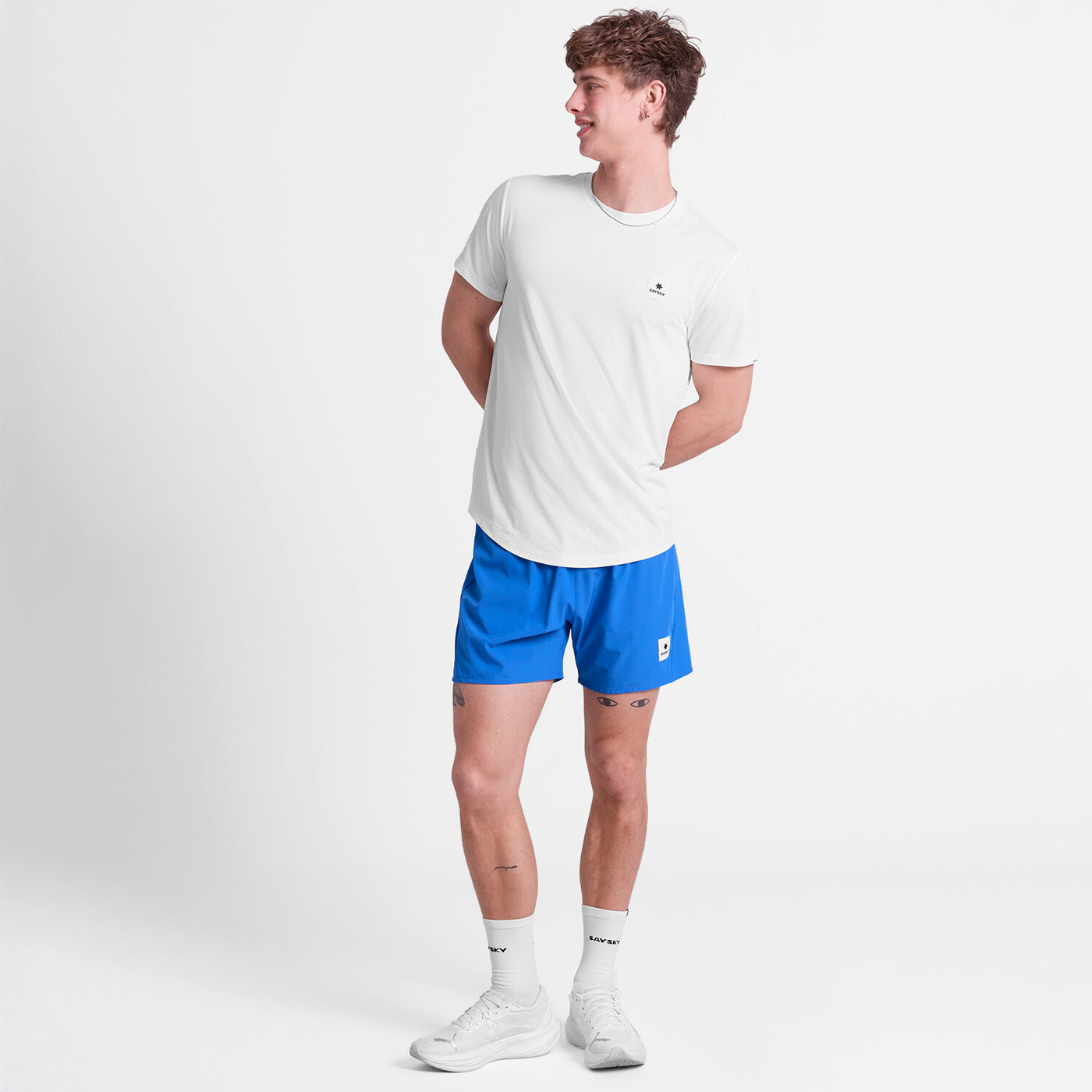 man wearing saysky pace 5 inch run shorts in blue colour with logo printed at front