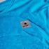 blue saysky singlet with reactive fabric that shows a flower pattern when wet