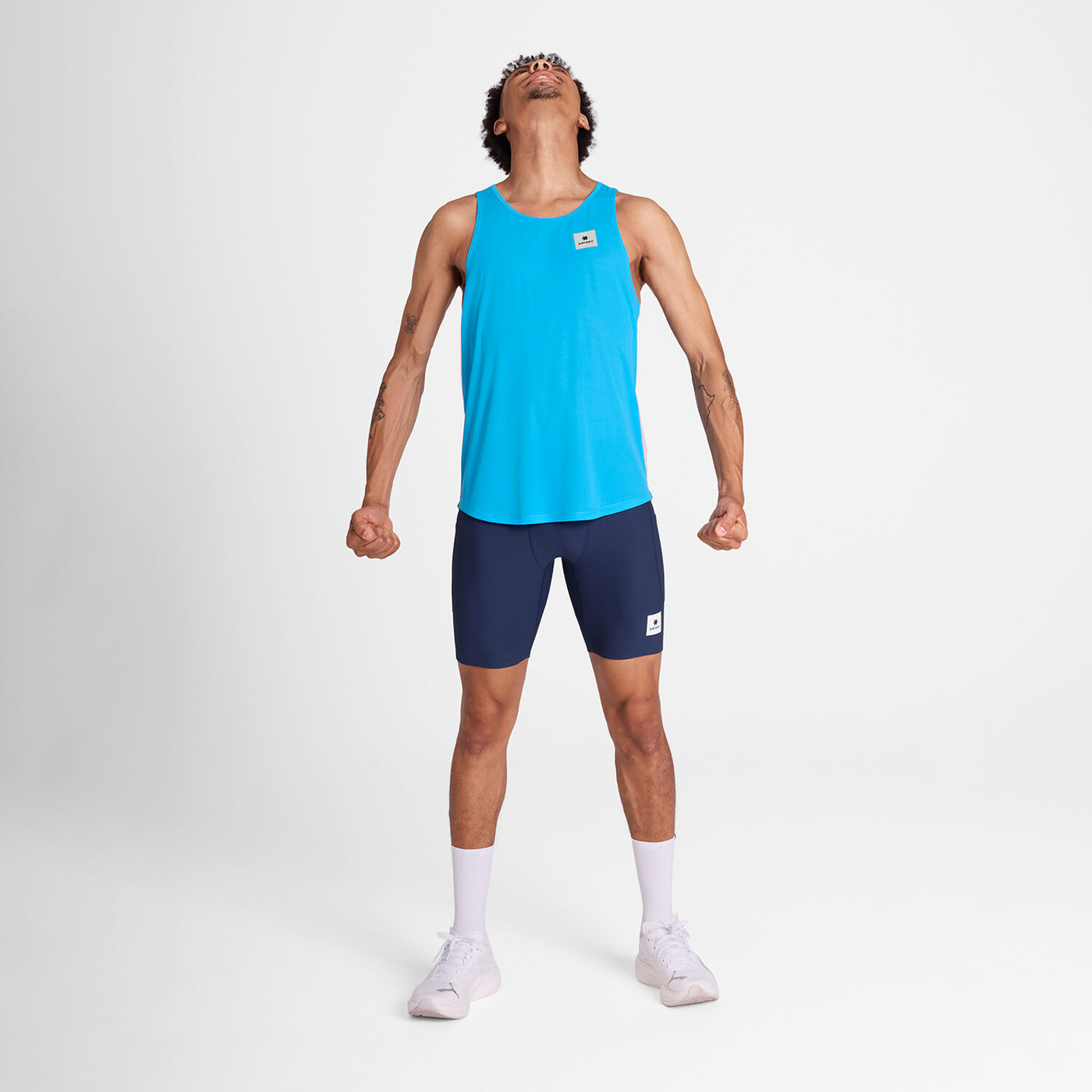 man wearing blue saysky singlet with reactive fabric that shows a flower pattern when wet