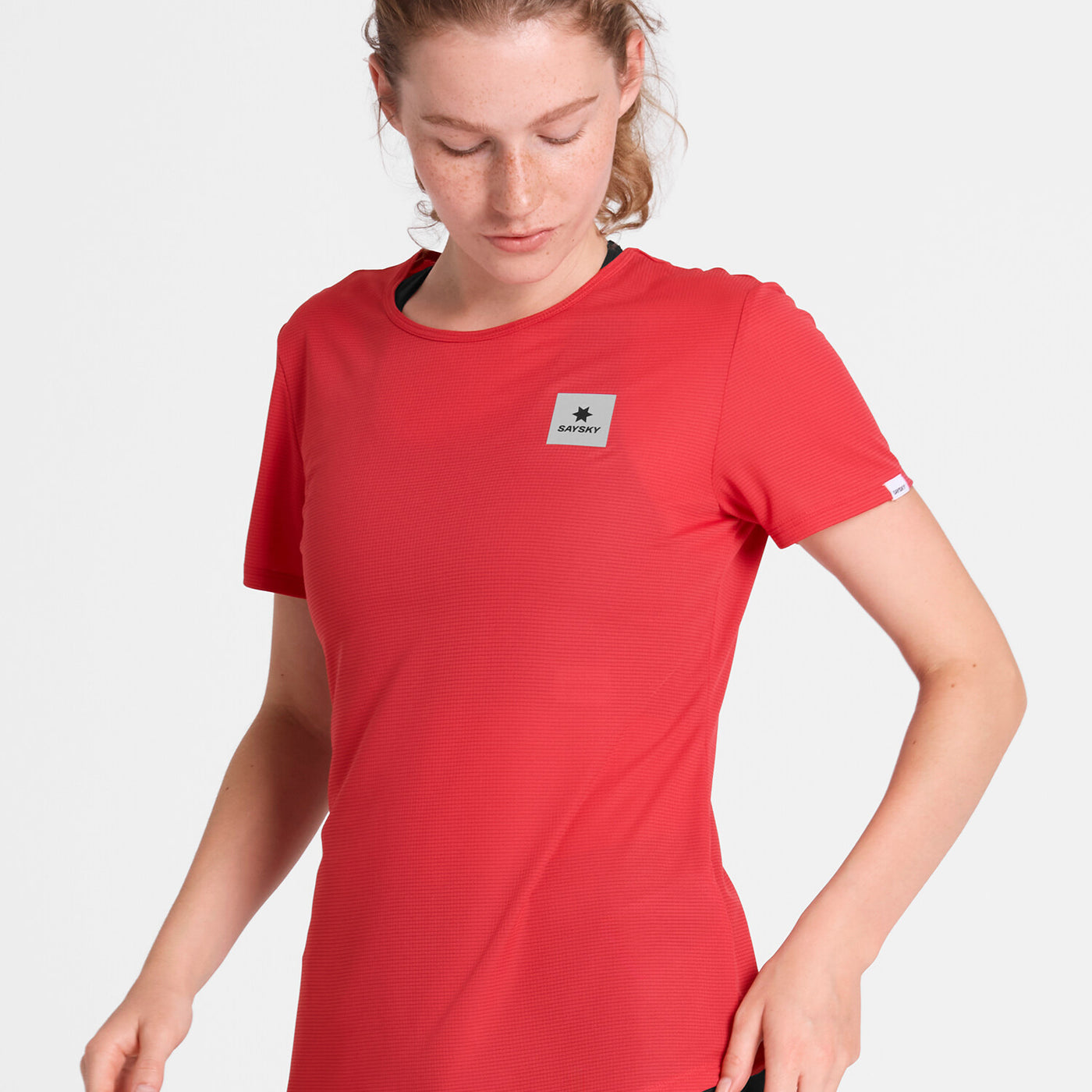woman wearing saysky run tee in red colour, with logo at front