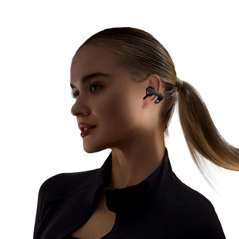 Woman wearing a black wireless shokz earbud