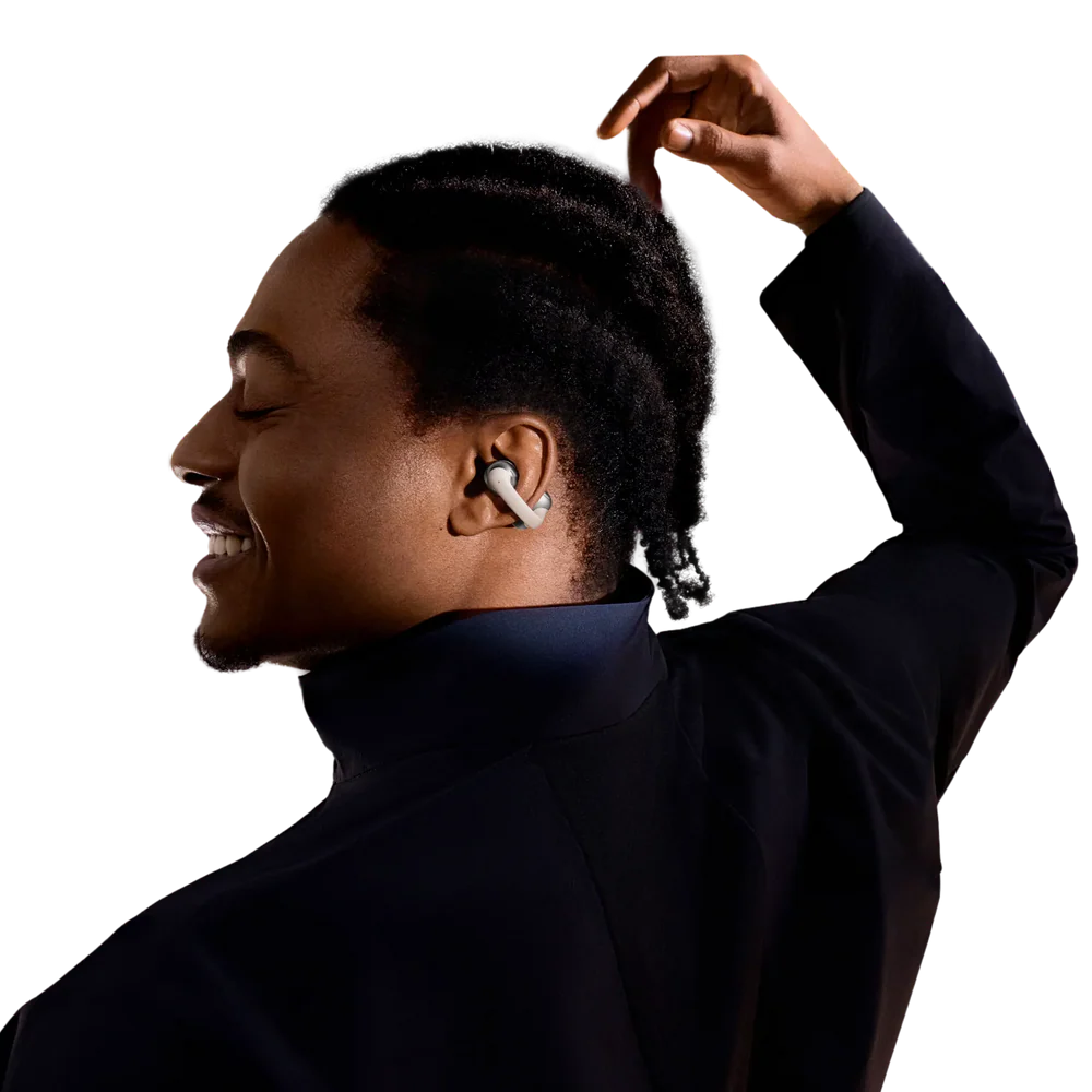 Person wearing silver white wireless shokz earbuds