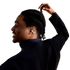 Person wearing silver white wireless shokz earbuds