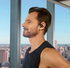 shokz openfit pro, wireless noise bone noise conducting earbuds, black colour, man wearing headphones with city in background