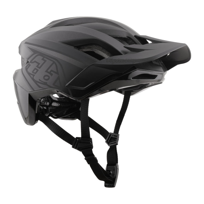 troy lee designs flowline se black matte mtb helmet with visor, side angled profile of helmet