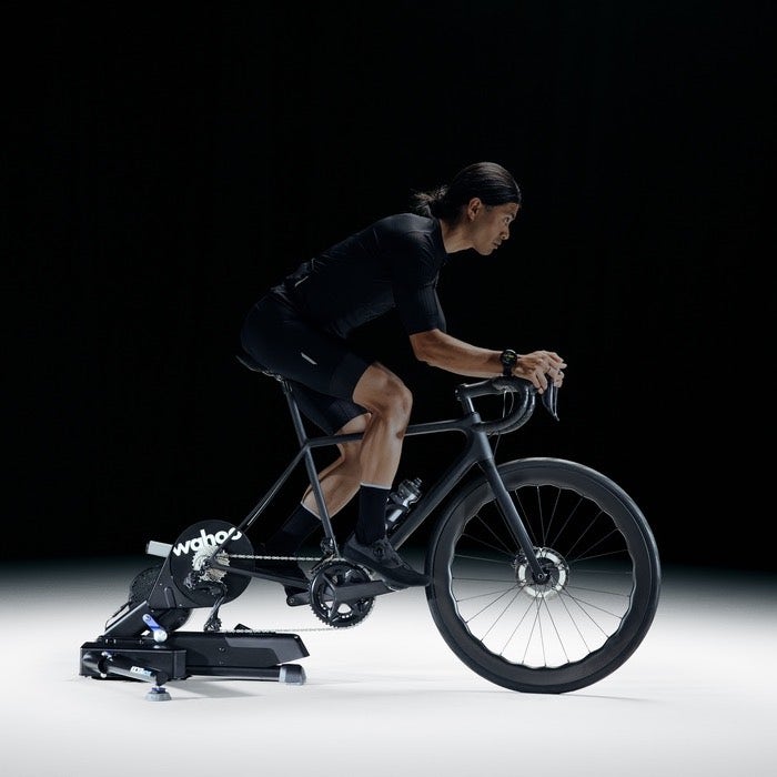 wahoo kickr move bike trainer, bike trainer with side to side movement, model riding bike with trainer