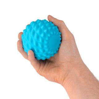 Person holding a fitness mad wave massage ball in their hand, to show size